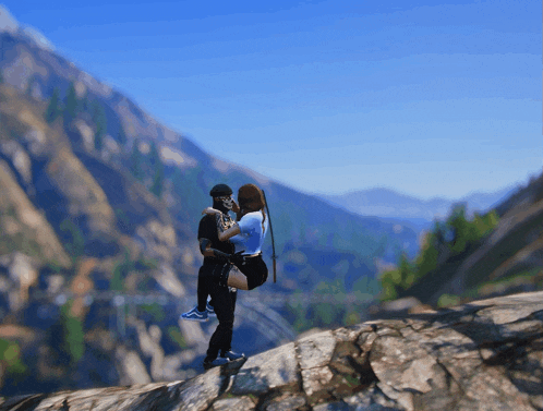 a man is carrying a woman on his shoulders while standing on top of a mountain