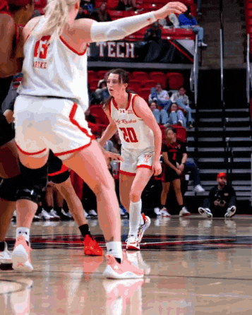 a female basketball player with the number 20 on her shirt