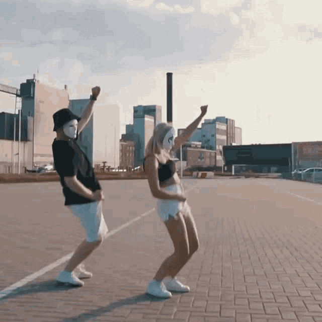 a man and a woman wearing masks are dancing