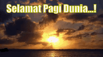 a sunset over a body of water with the words selamat pagi dunia written above it