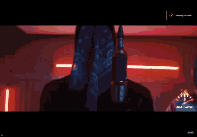 a man is singing into a microphone with the words recording has started on the screen