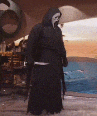 a grim reaper is holding a knife in his hand