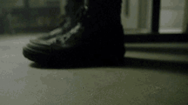 a close up of a person 's foot in a black boot