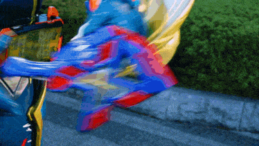 a blurred image of a person in a blue and red outfit