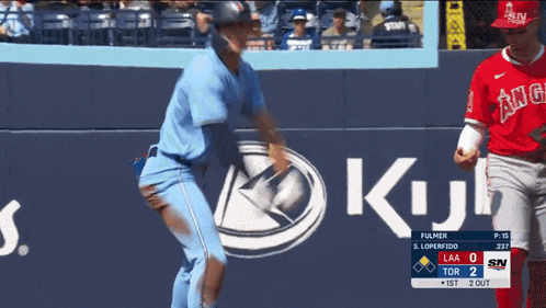 a baseball game is being played in front of a sign that says king