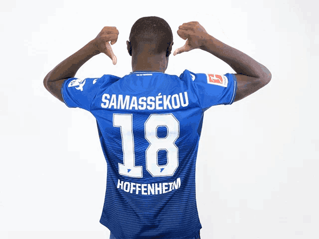 a man in a blue shirt with the number 18 on the back