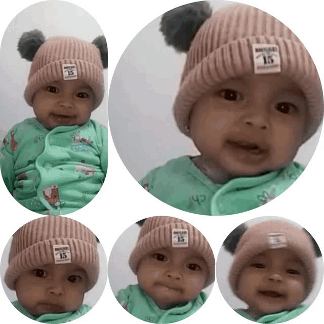 a baby wearing a pink beanie with the number 15 on the front