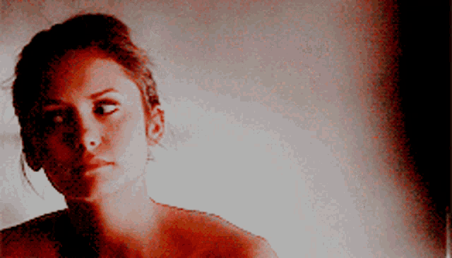 a woman without a shirt is looking at something