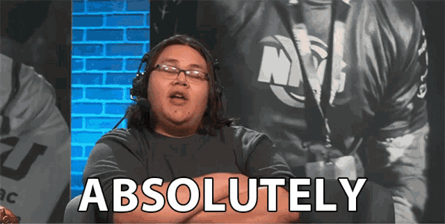 a man wearing headphones and glasses says absolutely with his arms crossed