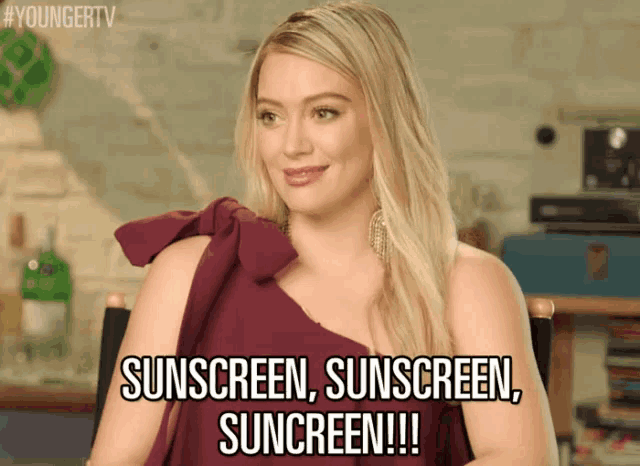 a woman wearing a purple dress says sunscreen sunscreen suncreen