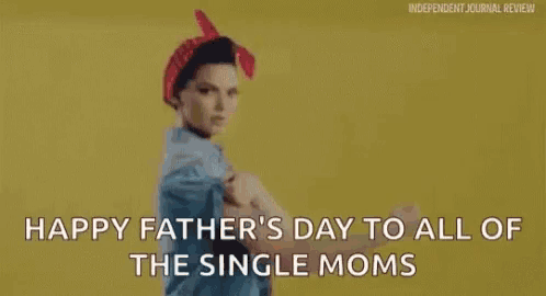 a woman is flexing her muscles for father 's day .
