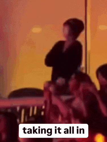 a blurry picture of a group of people with the words taking it all in