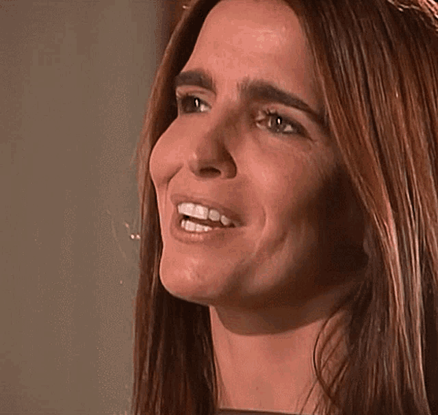 a close up of a woman 's face with her mouth open