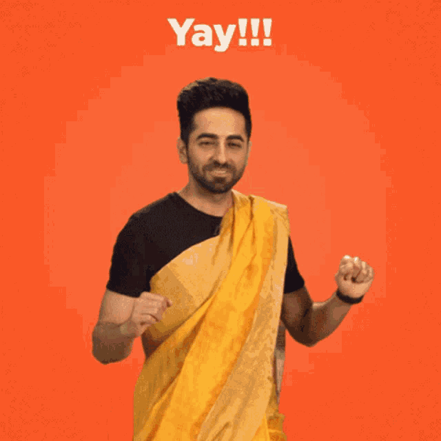 a man wearing a yellow saree is dancing with the words yay !!! below him