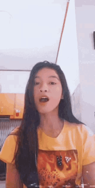 a young girl wearing a yellow t-shirt with a lion on it