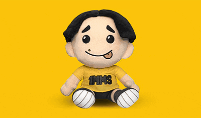 a stuffed toy with a yellow shirt and black hair
