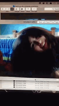 a computer screen shows a picture of a woman and says open with quicktime player on the bottom