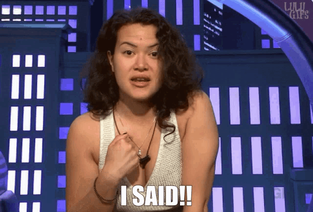 a woman says i said in front of a building