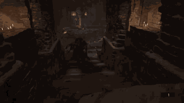 a person is walking down a staircase in a video game with a sword .