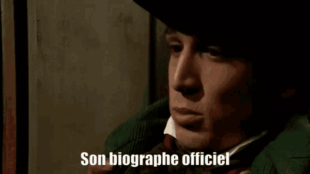 a man in a cowboy hat says son biographie officiel .