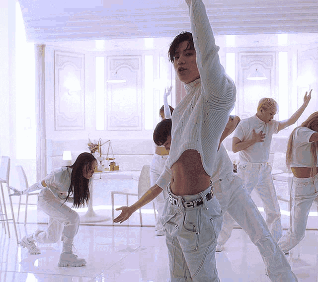 a group of people are dancing in a room and one of them is wearing a belt that says ' sd ' on it