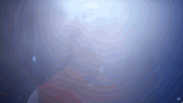 a person is standing in a dark room with a blue light shining on them