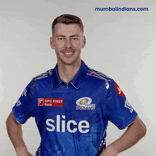 a man wearing a blue shirt with slice written on it