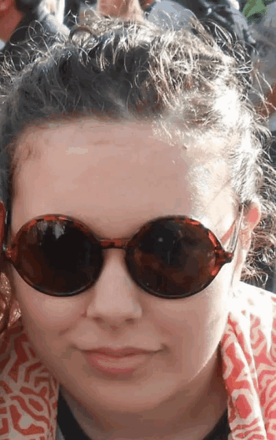 a close up of a woman wearing sunglasses