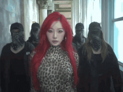 a woman with red hair wearing a leopard print top is surrounded by masked people
