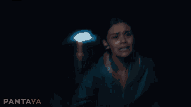 a blurry picture of a woman holding a flashlight with pantaya written on the bottom