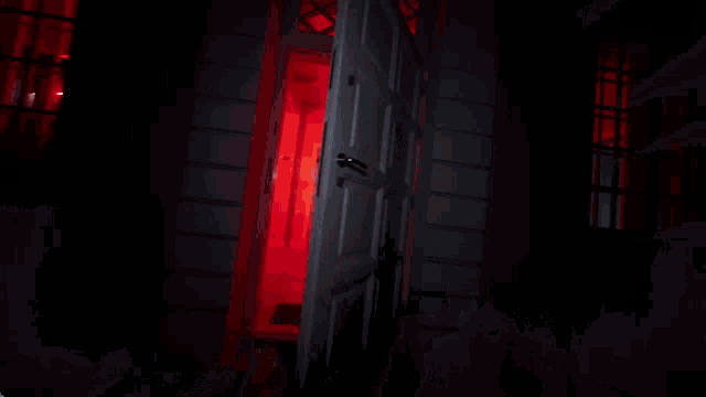 a man standing in a hallway with red lights