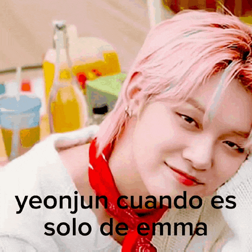 a young man with pink hair is wearing a red bandana and a white sweater ..