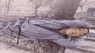 a painting of a person wrapped in a blue cloth