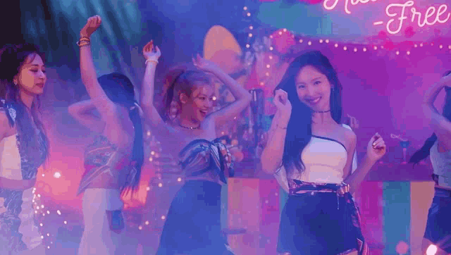 a group of women are dancing in front of a sign that says - free