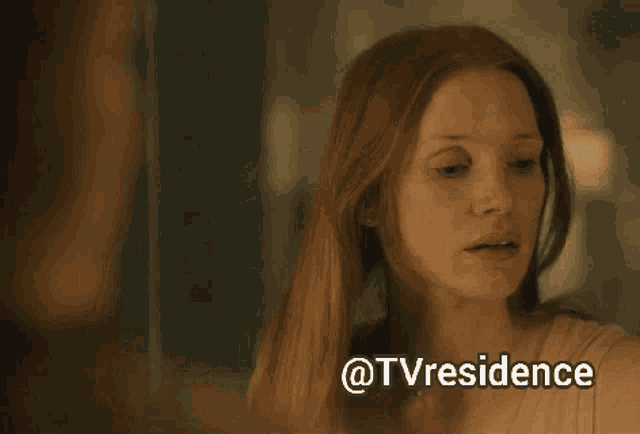 a woman is looking at herself in a mirror with the words @tvresidence above her