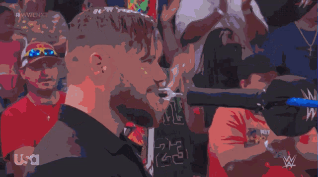 a man with the number 23 on his shirt stands in front of a crowd