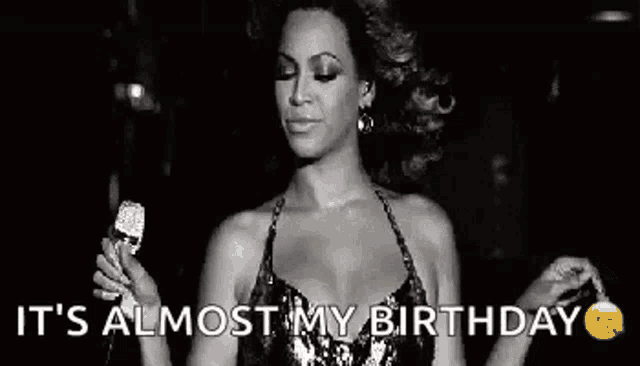 a black and white photo of a woman holding a microphone and saying it 's almost my birthday .