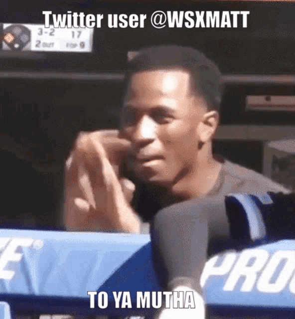 a man sitting in a stadium with the words twitter user @wsxmatt to ya mutha written below him