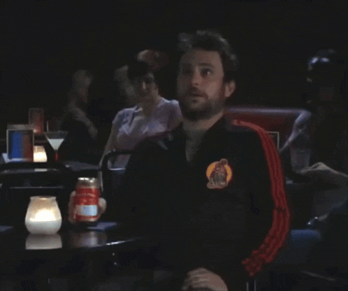 a man sitting at a table with a can of soda in front of him