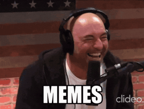 a man wearing headphones laughs in front of a microphone and the word memes is on the screen