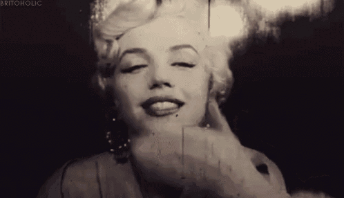 a black and white photo of a woman with her eyes closed .