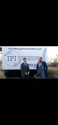 three men stand in front of an ipi interventional pain institute truck
