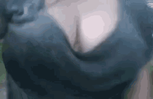a woman 's breasts are shown in a blurry photo .