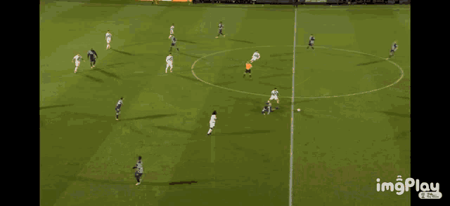 a soccer game is being played on a field that has a watermark that says imgplay