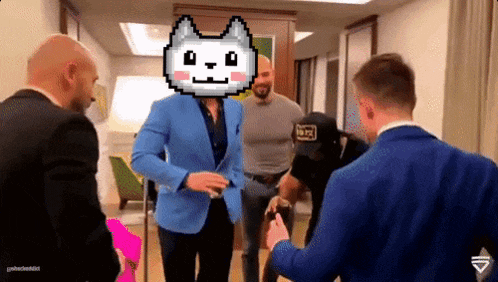 a man in a blue jacket has a pixel cat face on his head