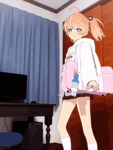 a girl is holding a pink bag with a bunny on it