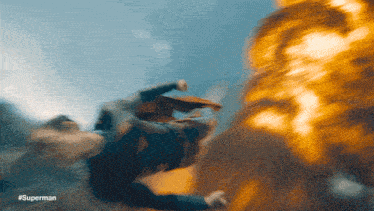 a blurred image of a man flying with #superman written on the bottom