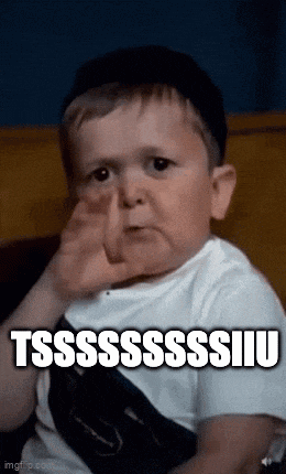 a little boy is sitting on a couch covering his nose with his hand .