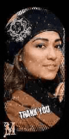 a close up of a woman wearing a hat and scarf with a thank you bracelet on her neck .