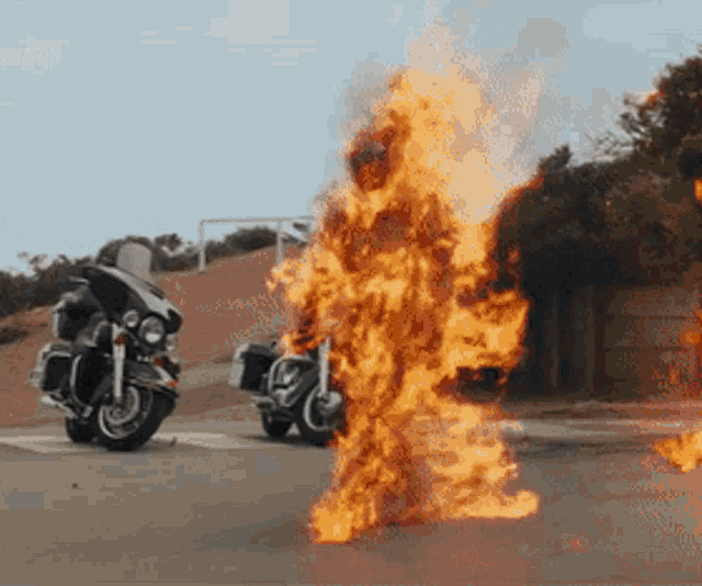 two police motorcycles are on fire on a street